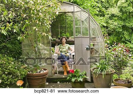Woman Sitting In Backyard Greenhouse Stock Image Bcp821 81