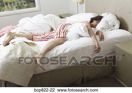 Woman sleeping in bed View Large Photo Image Stock Image - Woman sleeping in bed. Fotosearch