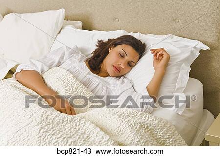 Woman sleeping in comfortable bed View Large Photo Image Stock Image - Woman sleeping in comfortable bed. Fotosearch