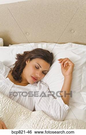 Woman sleeping in comfortable bed View Large Photo Image Stock Photograph - Woman sleeping in comfortable bed. Fotosearch