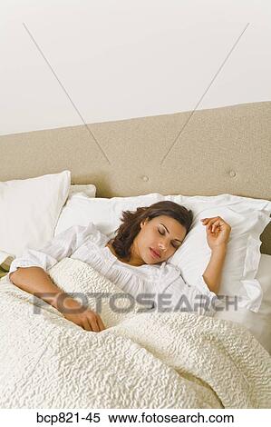 Woman sleeping in comfortable bed View Large Photo Image Stock Photography - Woman sleeping in comfortable bed. Fotosearch