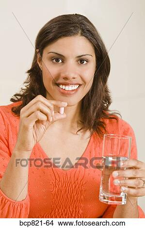 Woman taking vitamin View Large Photo Image Picture - Woman taking vitamin. Fotosearch