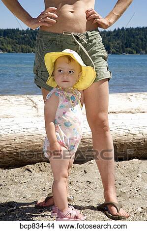 Baby girl standing with her mother on the beach View Large Photo Image Picture - Baby girl standing with her mother on the beach. Fotosearch