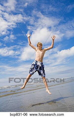 Boy jumping on the beach, Washington State, USA View Large Photo Image Stock Photograph - Boy jumping on the beach, Washington State, USA. Fotosearch