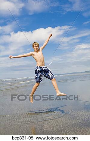 Boy jumping on the beach, Washington State, USA View Large Photo Image Stock Photography - Boy jumping on the beach, Washington State, USA. Fotosearch