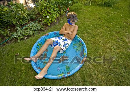 Boy wearing snorkel and lying in a wading pool View Large Photo Image Stock Image - Boy wearing snorkel and lying in a wading pool. Fotosearch