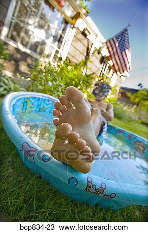 Boy wearing snorkel and lying in a wading pool View Large Photo Image Stock Image - Boy wearing snorkel and lying in a wading pool. Fotosearch
