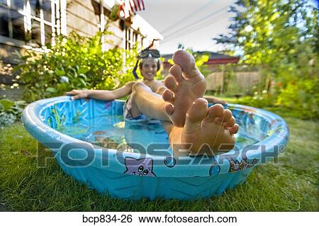 Boy wearing snorkel and lying in a wading pool View Large Photo Image Stock Photograph - Boy wearing snorkel and lying in a wading pool. Fotosearch
