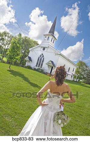 Stock Image - Bride standing near a church, East Meredith, New York State, USA. Fotosearch