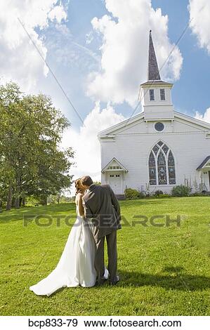 Bridegroom kissing his bride in front of a church, East Meredith, New York State, USA View Large Photo Image Stock Photo - Bridegroom kissing his bride in front of a church, East Meredith, New York State, USA. Fotosearch