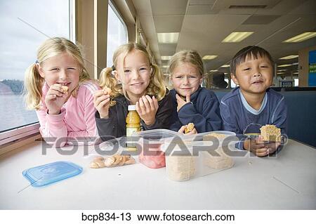 Children eating cookies and candies on a ferry boat View Large Photo Image Stock Image - Children eating cookies and candies on a ferry boat. Fotosearch