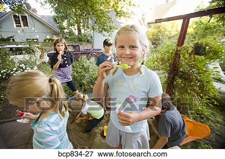 Stock Photo - Children eating popsicles. Fotosearch