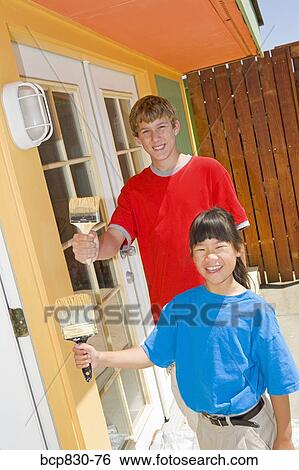 Stock Photograph - Children painting their home. Fotosearch