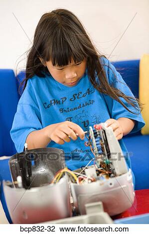 Close-up of a girl repairing radio View Large Photo Image Stock Image - Close-up of a girl repairing radio. Fotosearch