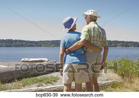 Couple at a beach, Washington State, USA View Large Photo Image Stock Photo - Couple at a beach, Washington State, USA. Fotosearch