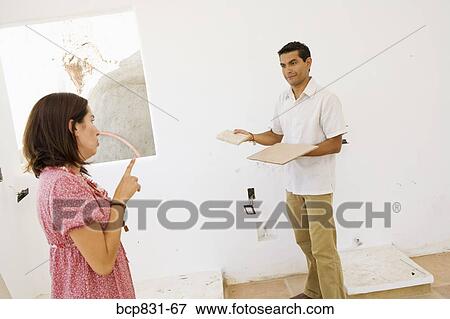 Couple choosing tiles View Large Photo Image Stock Photo - Couple choosing tiles. Fotosearch