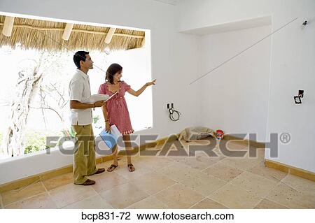 Couple holding document and discussing View Large Photo Image Stock Image - Couple holding document and discussing. Fotosearch