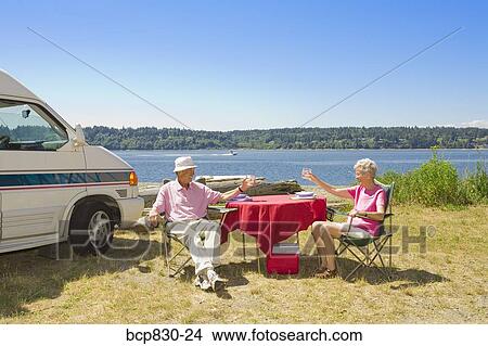Couple holding glasses of wine at a beach, Washington State, USA View Large Photo Image Picture - Couple holding glasses of wine at a beach, Washington State, USA. Fotosearch