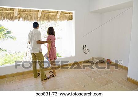 Couple looking through a window View Large Photo Image Stock Image - Couple looking through a window. Fotosearch