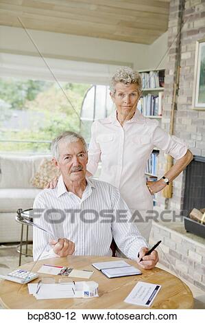 Stock Image - Couple preparing home finance budget. Fotosearch
