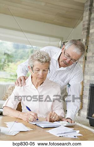 Couple preparing home finance budget View Large Photo Image Stock Photography - Couple preparing home finance budget. Fotosearch