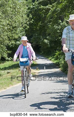 Couple riding their bicycles, Washington State, USA View Large Photo Image Picture - Couple riding their bicycles, Washington State, USA. Fotosearch