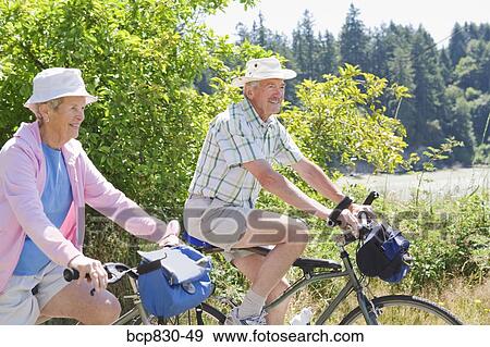 Stock Photo - Couple riding their bicycles, Washington State, USA. Fotosearch