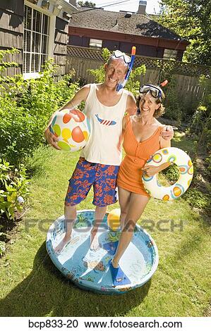 Couple wearing snorkels and standing in a wading pool View Large Photo Image Stock Image - Couple wearing snorkels and standing in a wading pool. Fotosearch
