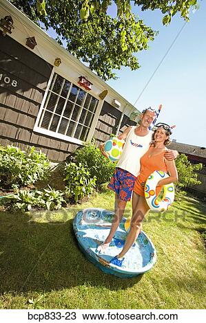 Couple wearing snorkels and standing in a wading pool View Large Photo Image Stock Image - Couple wearing snorkels and standing in a wading pool. Fotosearch
