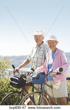 Stock Photo - Couple with their bicycles, Washington State, USA. Fotosearch
