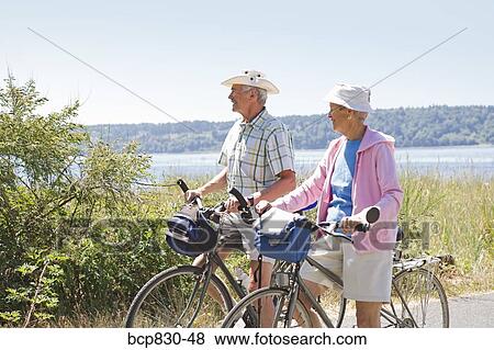 Stock Photo - Couple with their bicycles, Washington State, USA. Fotosearch