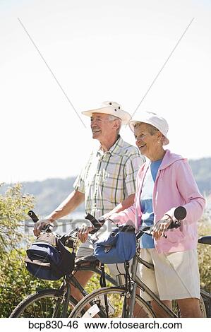 Couple with their bicycles, Washington State, USA View Large Photo Image Stock Photograph - Couple with their bicycles, Washington State, USA. Fotosearch