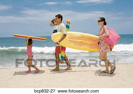 Stock Photo - Couple with their children on the beach. Fotosearch