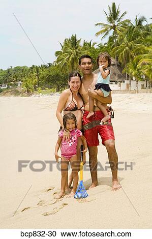 Couple with their children standing on the beach View Large Photo Image Stock Image - Couple with their children standing on the beach. Fotosearch