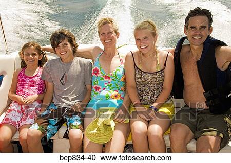 Family sitting in a motorboat View Large Photo Image Stock Image - Family sitting in a motorboat. Fotosearch