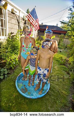 Family wearing snorkels and standing in a wading pool View Large Photo Image Picture - Family wearing snorkels and standing in a wading pool. Fotosearch