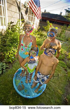 Family wearing snorkels and standing in a wading pool View Large Photo Image Stock Photography - Family wearing snorkels and standing in a wading pool. Fotosearch