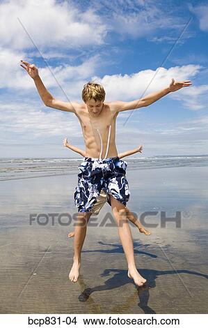 Friends jumping on the beach, Washington State, USA View Large Photo Image Picture - Friends jumping on the beach, Washington State, USA. Fotosearch