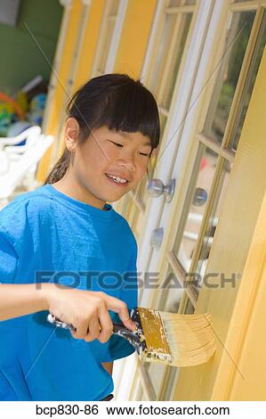 Girl painting her home View Large Photo Image Stock Photograph - Girl painting her home. Fotosearch