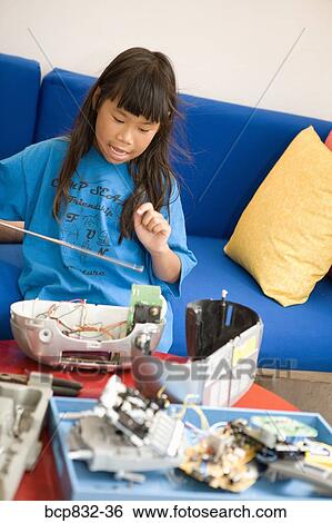 Stock Photograph - Girl repairing a radio. Fotosearch