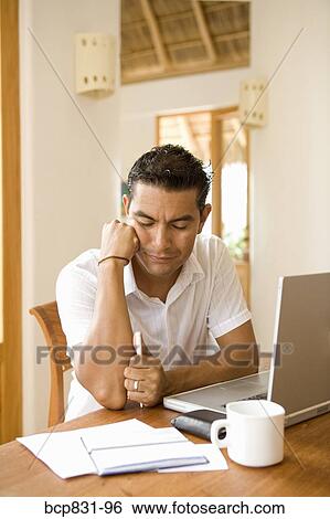 Man preparing home finance budget at home View Large Photo Image Stock Photograph - Man preparing home finance budget at home. Fotosearch