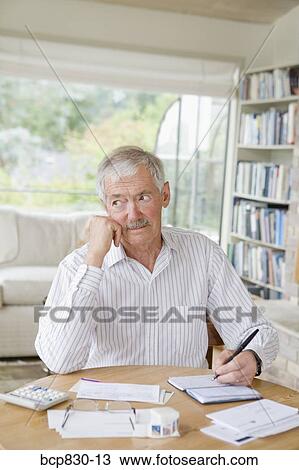 Man preparing home finance budget View Large Photo Image Stock Image - Man preparing home finance budget. Fotosearch