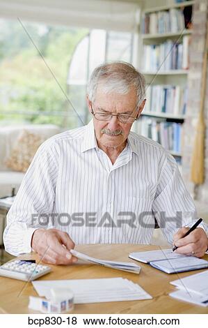 Man preparing home finance budget View Large Photo Image Stock Photo - Man preparing home finance budget. Fotosearch