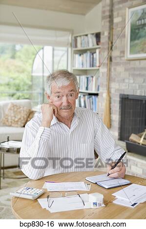 Man preparing home finance budget View Large Photo Image Stock Photograph - Man preparing home finance budget. Fotosearch