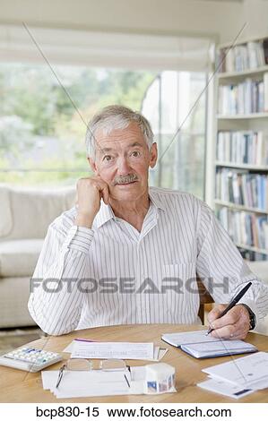 Man preparing home finance budget View Large Photo Image Stock Photography - Man preparing home finance budget. Fotosearch