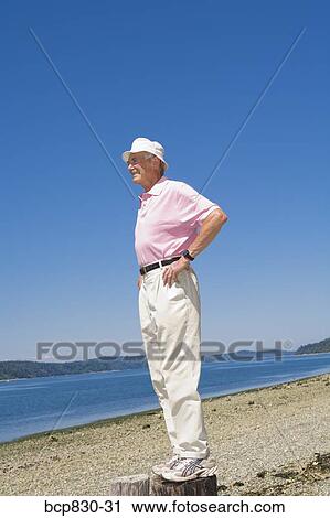Man standing at a beach, Washington State, USA View Large Photo Image Stock Image - Man standing at a beach, Washington State, USA. Fotosearch