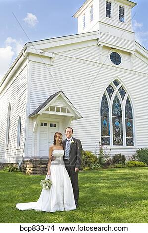 Newlywed couple standing in front of a church, East Meredith, New York State, USA View Large Photo Image Picture - Newlywed couple standing in front of a church, East Meredith, New York State, USA. Fotosearch