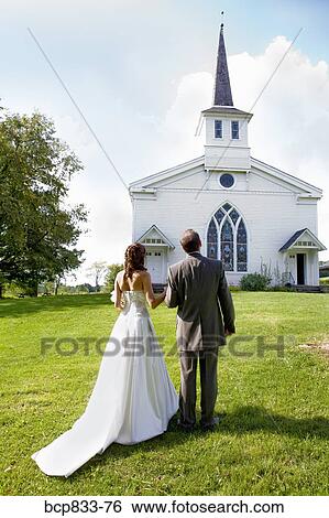 Newlywed couple standing in front of a church, East Meredith, New York State, USA View Large Photo Image Stock Photograph - Newlywed couple standing in front of a church, East Meredith, New York State, USA. Fotosearch