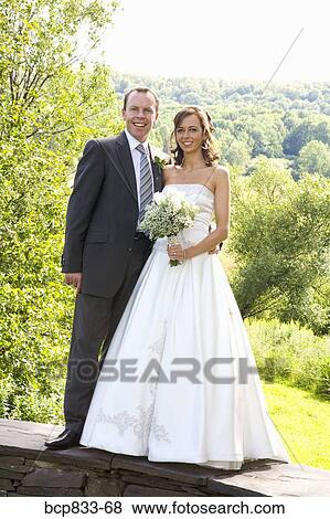 Newlywed couple standing together, East Meredith, New York State, USA View Large Photo Image Stock Photo - Newlywed couple standing together, East Meredith, New York State, USA. Fotosearch