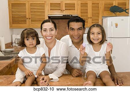 Parents with their daughters in the kitchen View Large Photo Image Stock Image - Parents with their daughters in the kitchen. Fotosearch